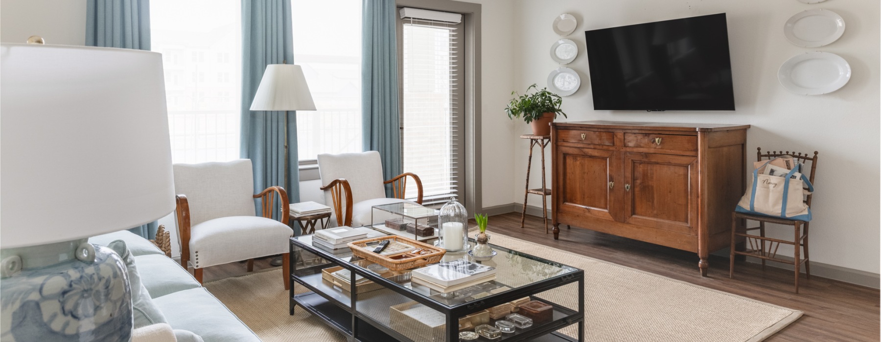 a living room with a tv and tables