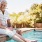 a man and woman sitting by a pool